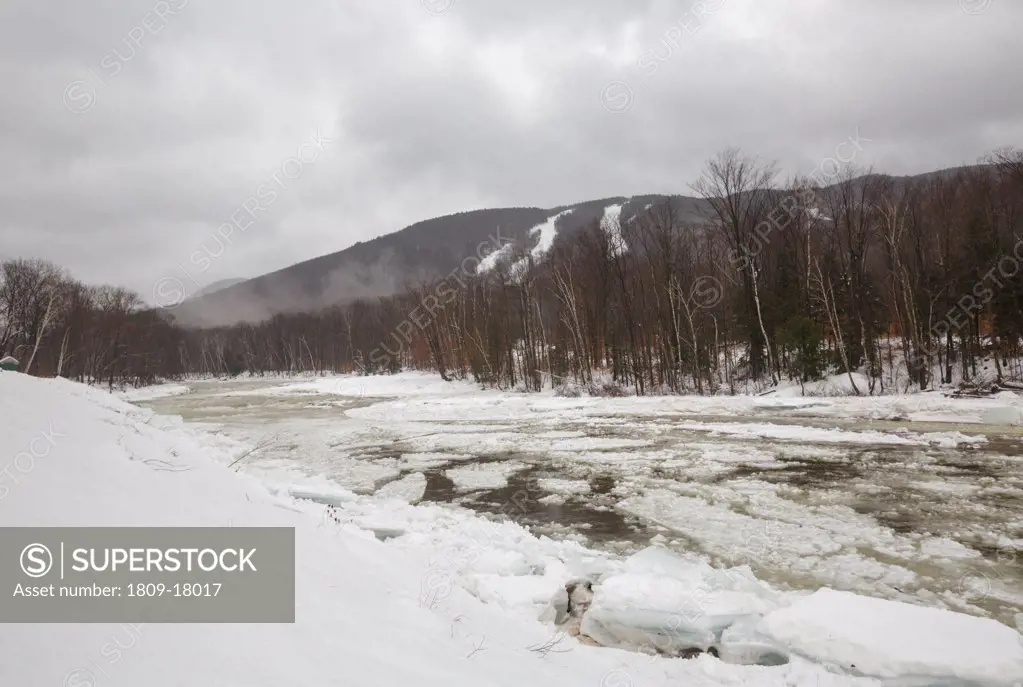 Ice flowing down the East Branch of the Pemigewasset River in Lincoln, New Hampshire USA during a rain and wintry mix during the winter months