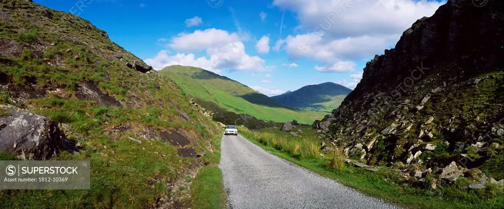 Car driving along narrow mountain road