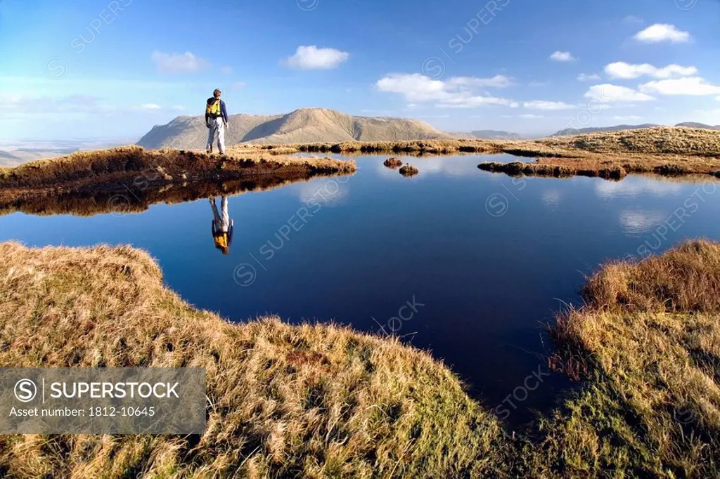 Connemara, Co Galway, Ireland, Person walking near a bog pool