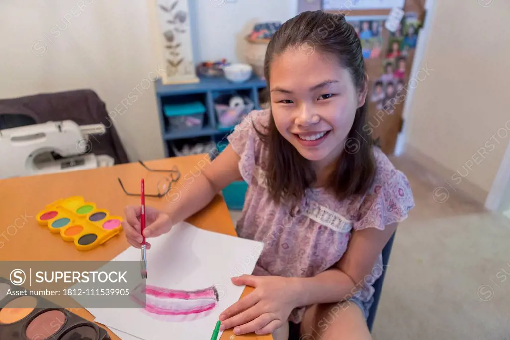 Teen girl with a Learning Disability using paints