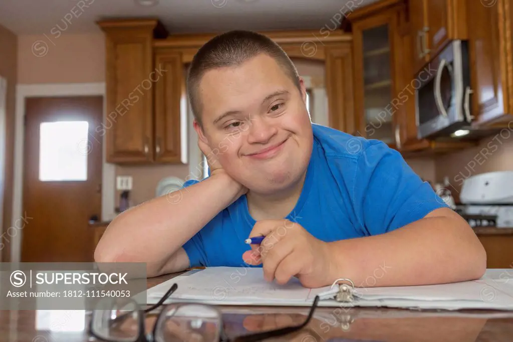 Teen with Down Syndrome studying