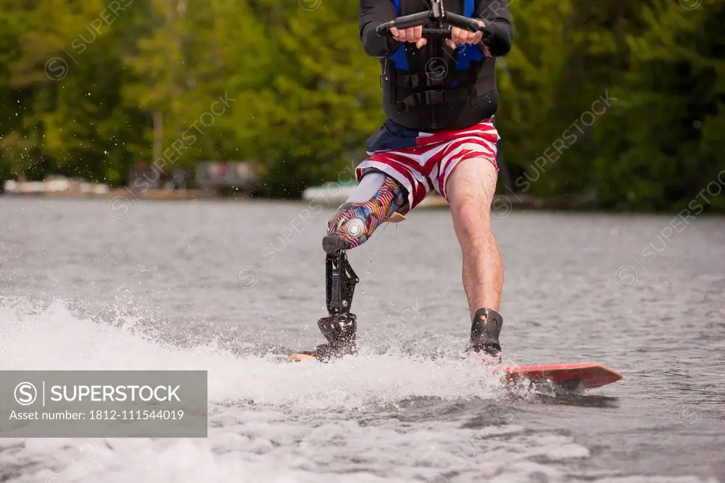 Athlete with an artificial leg water skiing