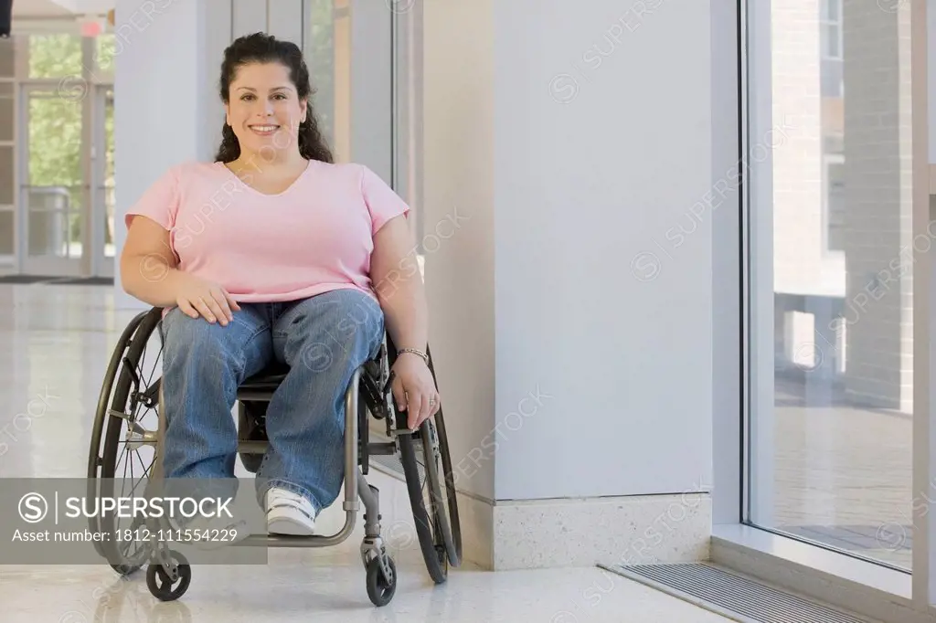 Woman with Spina Bifida sitting in a wheelchair and smiling