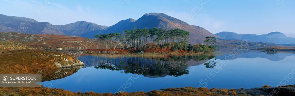 Reflection Of Trees And Mountains In A Lake, Derryclare Lough, Twelve Bens, Connemara, County Galway, Republic Of Ireland