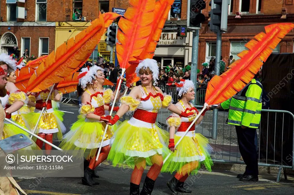 Dublin, Ireland, Women In Costume Dance With Large Feathers As Part Of A Parade On O´connell Street