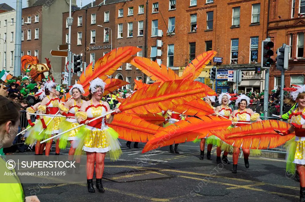 Dublin, Ireland, Women In Costume Dance With Large Feathers As Part Of A Parade On O´connell Street