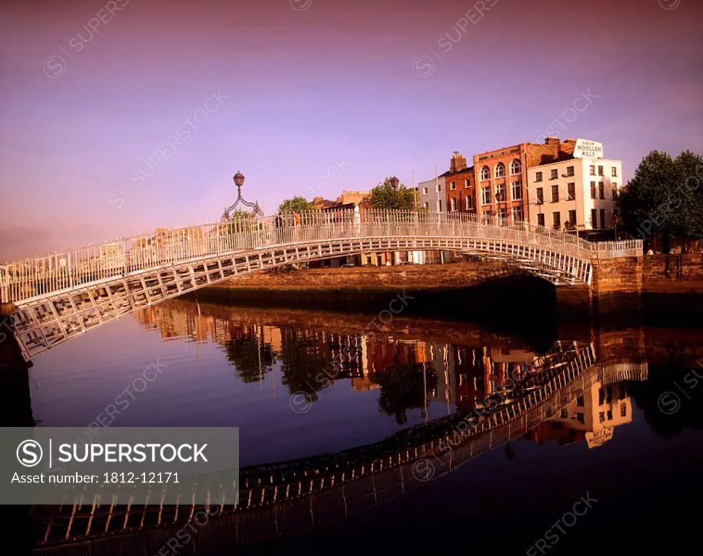 Ha´penny Bridge, River Liffey, Dublin, Ireland, Bridge Reflected In River Against Cityscape