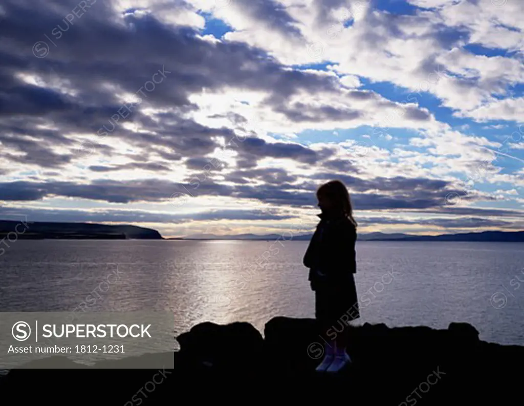 Girl standing by the Atlantic Ocean, Portstewart, Co. Londonderry, Ireland