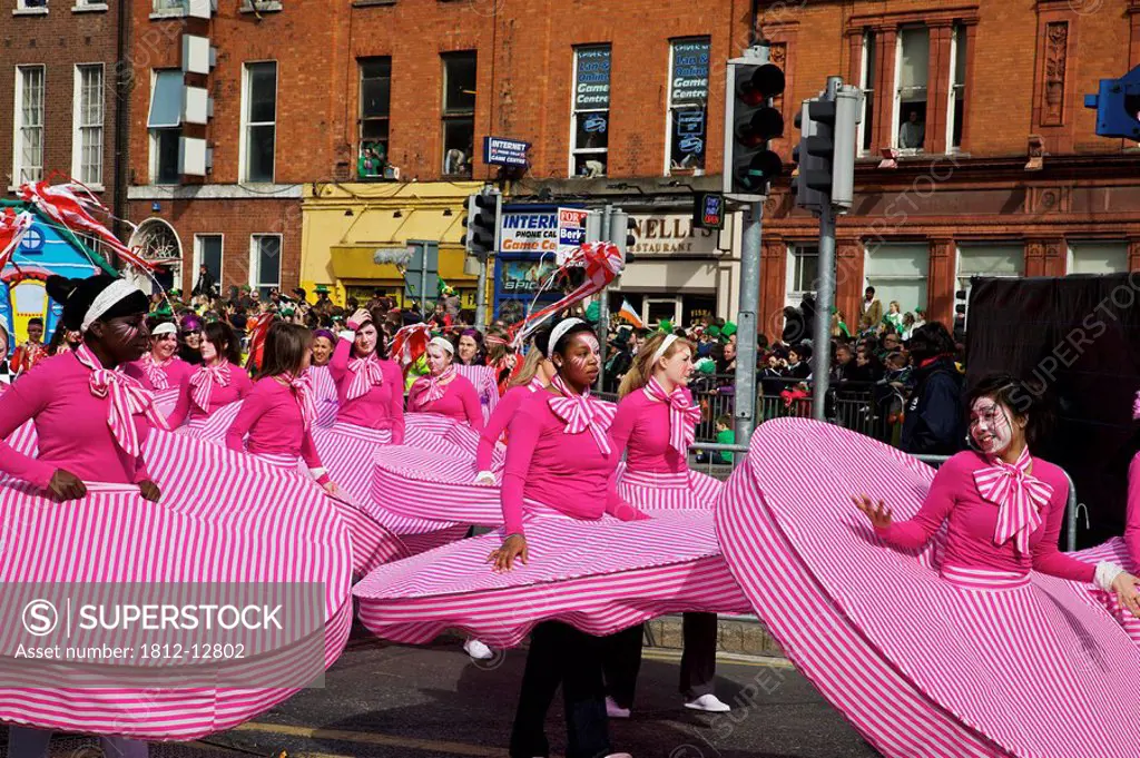 Dublin, ireland, people in costumes dancing on o´connell street as part of a parade