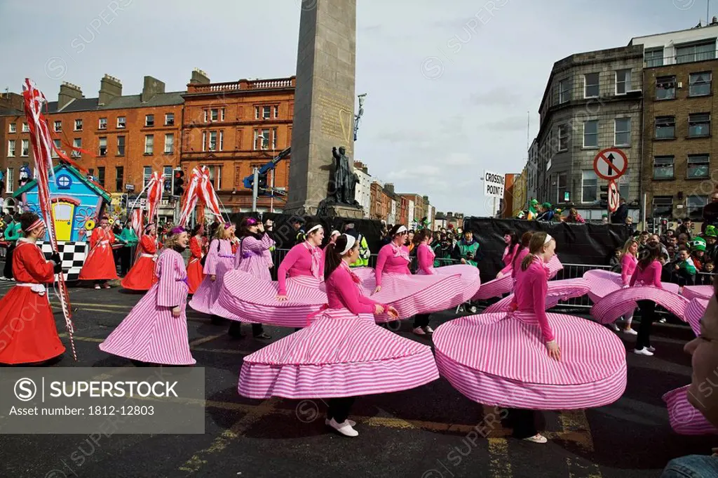 Dublin, ireland, people in costumes dancing on o´connell street as part of a parade