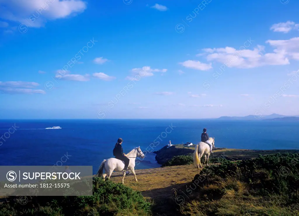 High Angle View Of People Riding Ponies Near The Sea Coast, Howth, Dublin, Republic Of Ireland