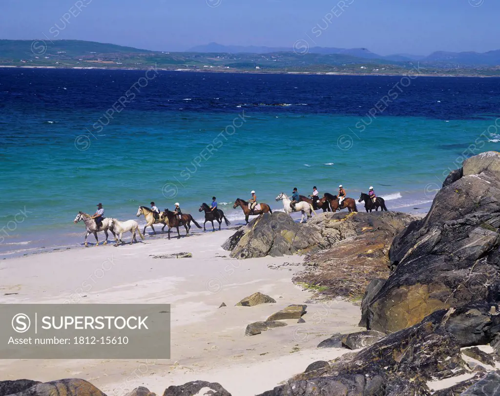 Tourists Horseback Riding On The Beach, Mannin Bay, Connemara, County Galway, Republic Of Ireland