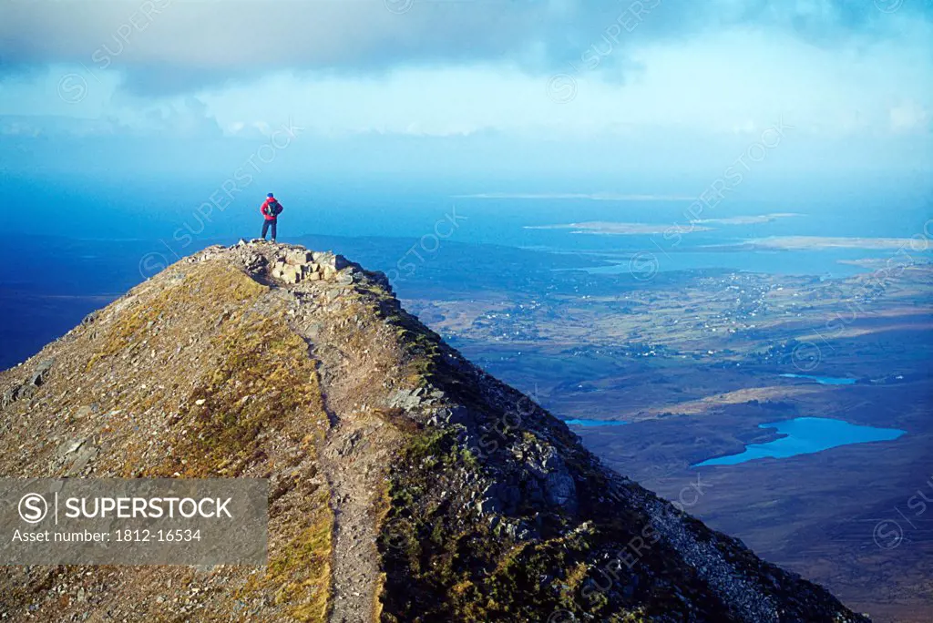 Mount Errigal, County Donegal, Ireland; Hiker On A Mountain Summit
