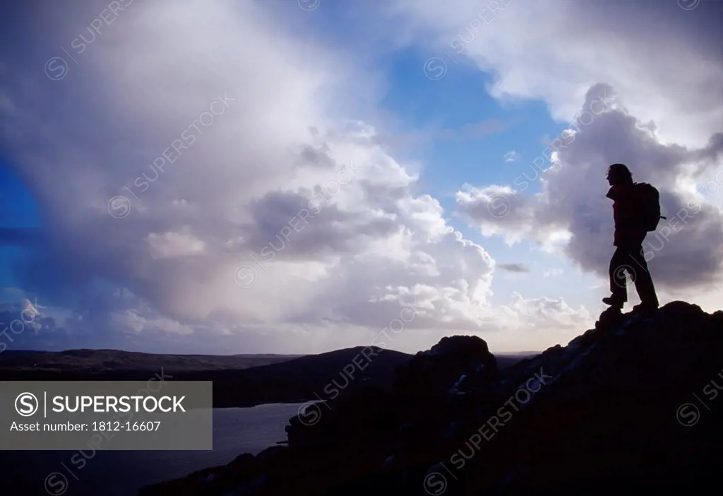 Tully Mountain, Connemara, County Galway, Ireland; Hiker On Mountain Summit