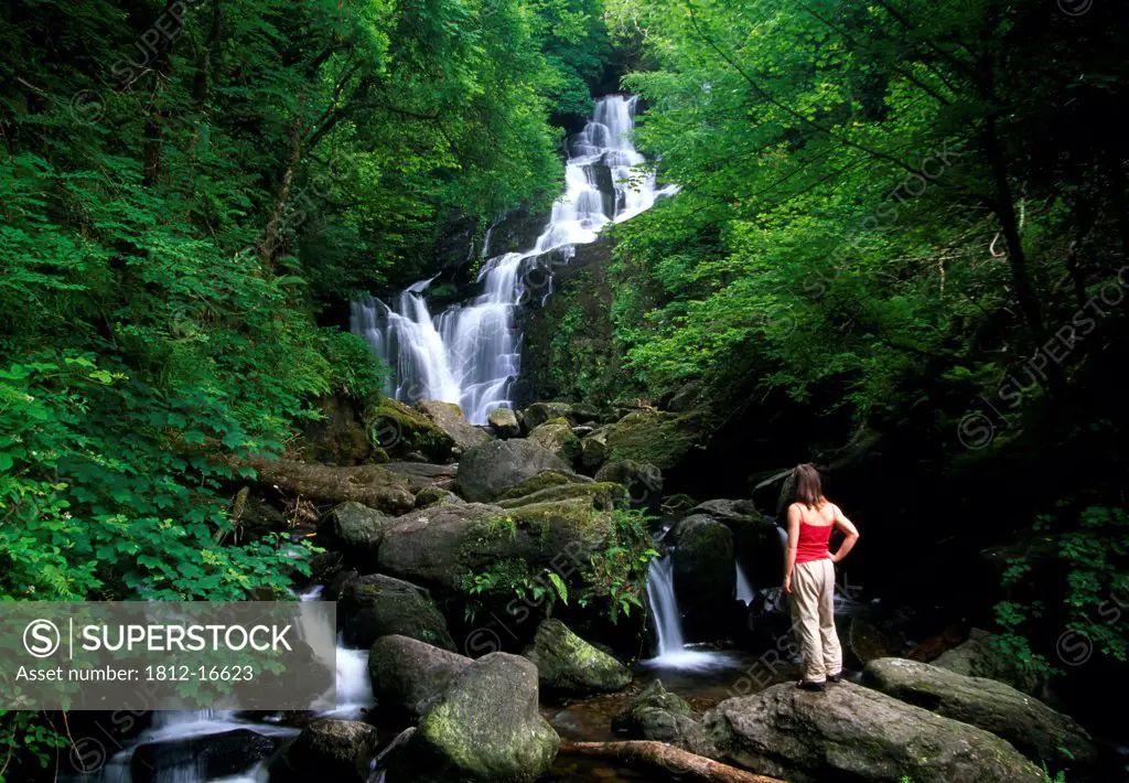 Torc Waterfall, Killarney National Park, County Kerry, Ireland; Woman Looking At Waterfall