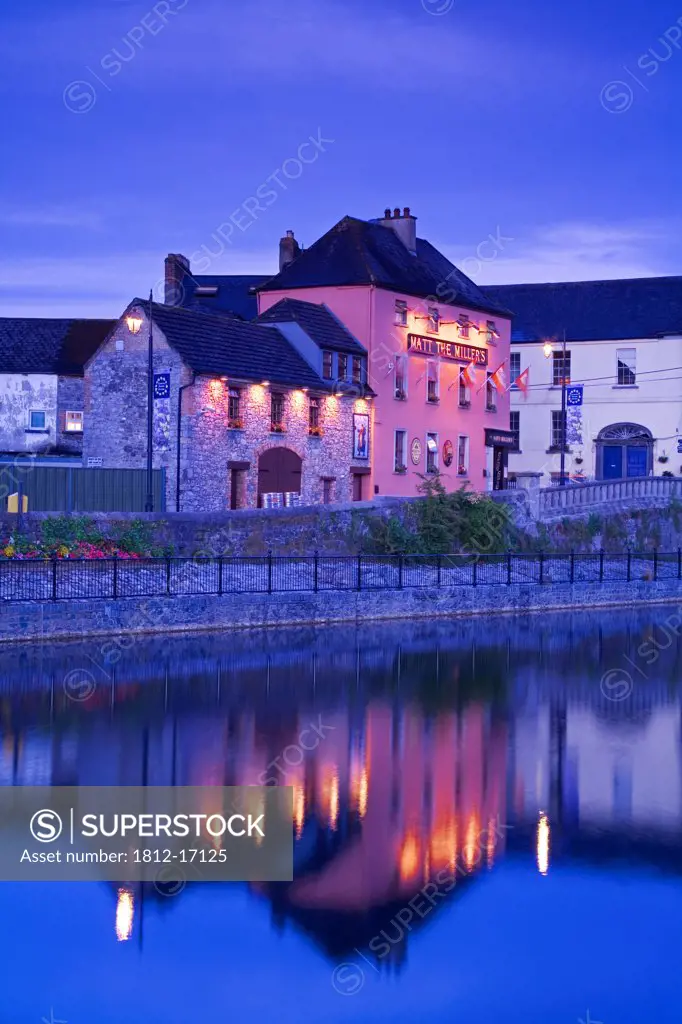 John's Quay & River Nore, Kilkenny City, County Kilkenny, Ireland; City Buildings By Riverside At Dusk
