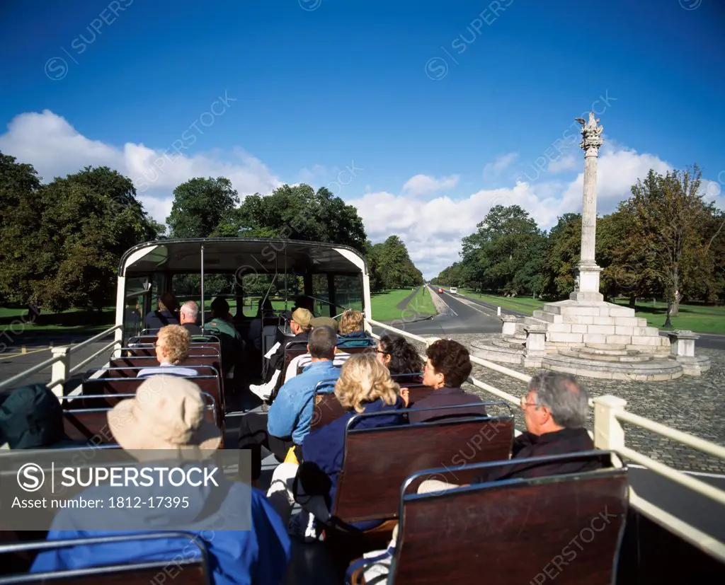 Phoenix Column, Phoenix Park, Dublin City, Ireland; Tourists On Open Top Bus Viewing Monument In Park