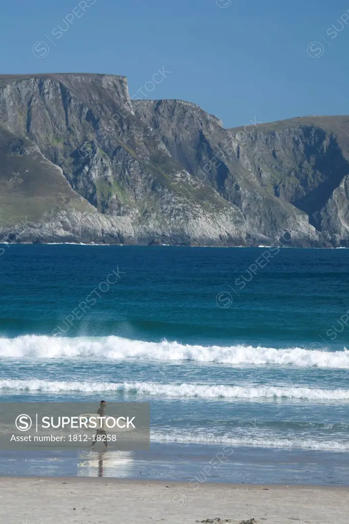 Achill Island, Co Mayo, Ireland; Surfer Walking Along Trawmore Beach
