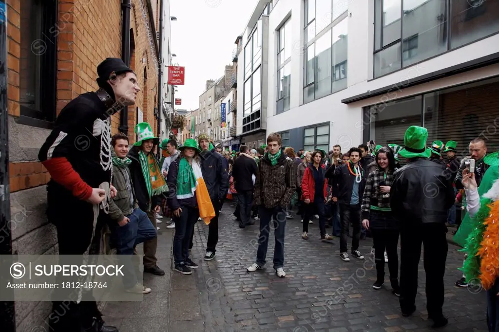 Dublin, Ireland; A Crowd Gathers In The Street To See A Performer For Saint Patrick's Day