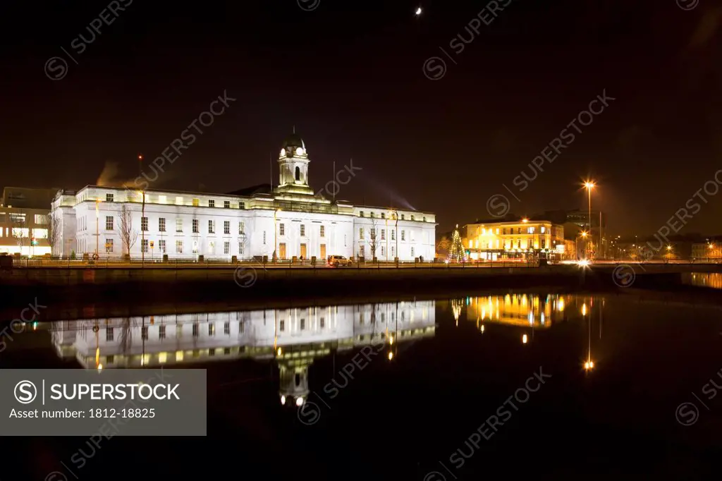 Cork, Cork County, Ireland; City Hall Illuminated At Night Along River Lee