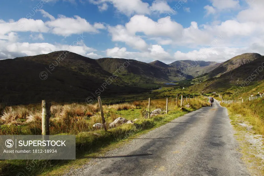 Lone Hiker On A Road In Black Valley Near Killarney In Munster Region; County Kerry, Ireland