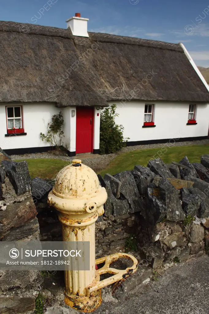 Thatched Cottage And A Fire Hydrant In Tully Cross In Connacht Region; Tully Cross, County Galway, Ireland