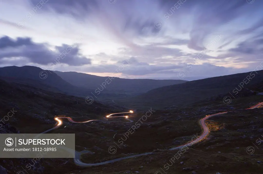 Car Lights Crossing The Healy Pass On A Winding Road In West Cork; County Cork, Ireland