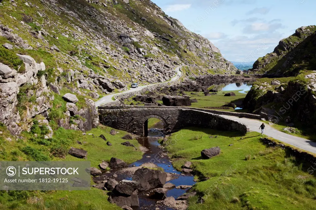 Walking On The Road Over A Bridge; Gap Of Dunloe, County Kerry, Ireland