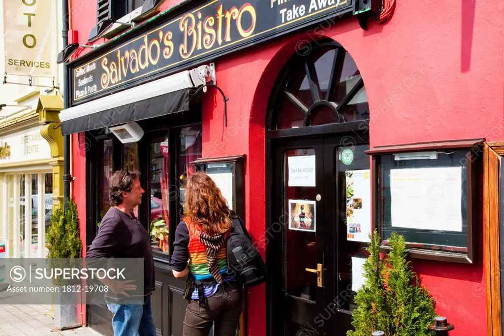 A Couple Read The Menu Posted Outside Salvado's Bistro; Kenmare County Kerry Ireland
