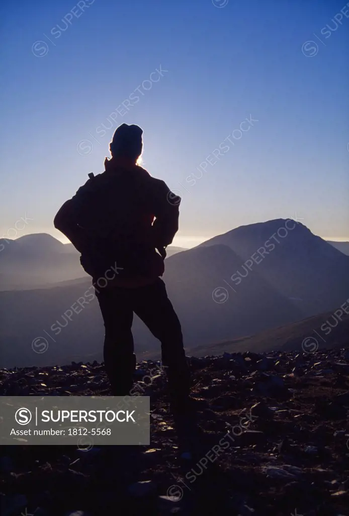Mount Errigal, County Donegal, Ireland; Hiker on Aghla looking at mountain peak