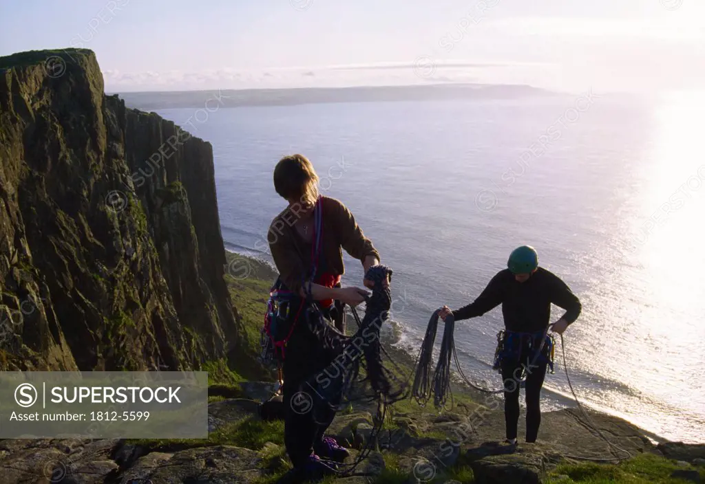 Fair Head, County Antrim, Ireland; Rock climbers ascending