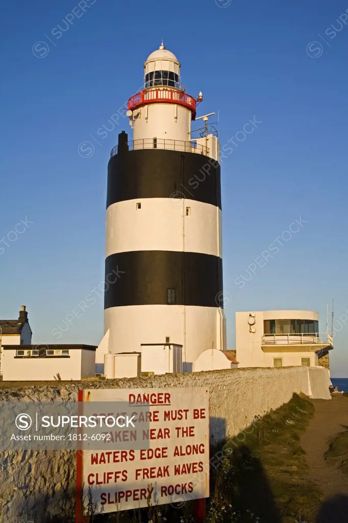 Hook Head, County Wexford, Ireland; Lighthouse with warning sign  