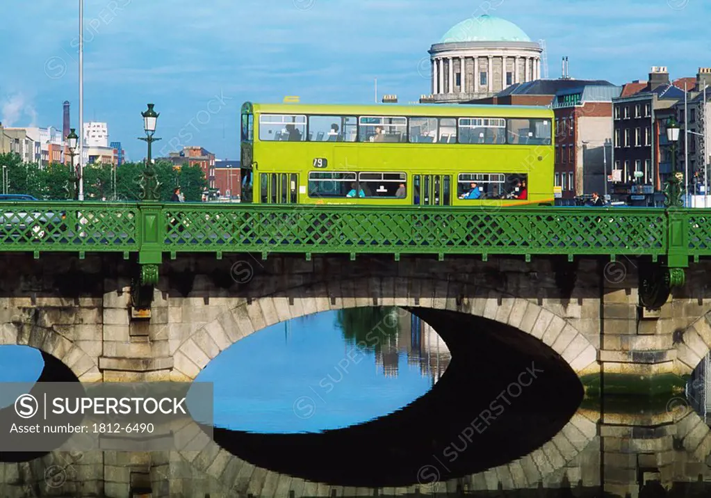 Dublin, Co Dublin, Ireland, Dublin bus going over the Capel St. Bridge with Four Courts in the background