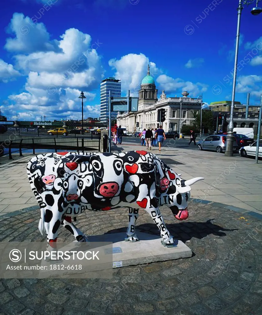 Dublin, Co Dublin, Ireland, Painted cattle sculpture with the Custom House in the distance