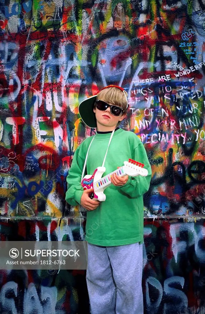 U2 Wall, Dublin, Co Dublin, Ireland, Boy holding a toy guitar
