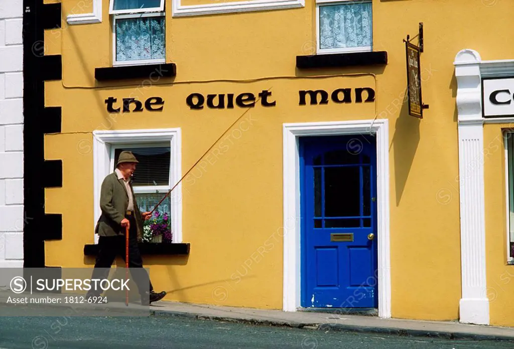 Cong, Co Mayo, Ireland, Man walking past a traditional pub