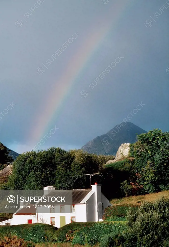 Sugarloaf Mountain, Glengarriff, Co Cork, Ireland, House with a rainbow and mountain in the distance
