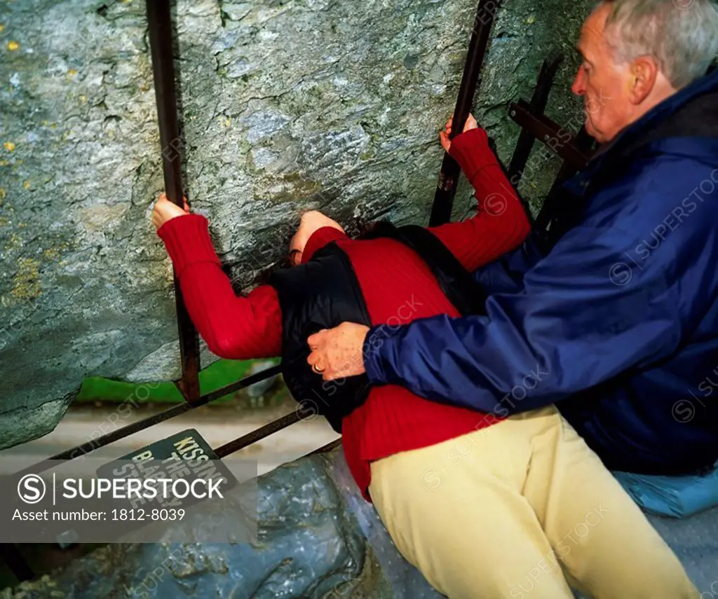 Blarney Castle, Co Cork, Ireland, Woman kissing the Blarney Stone