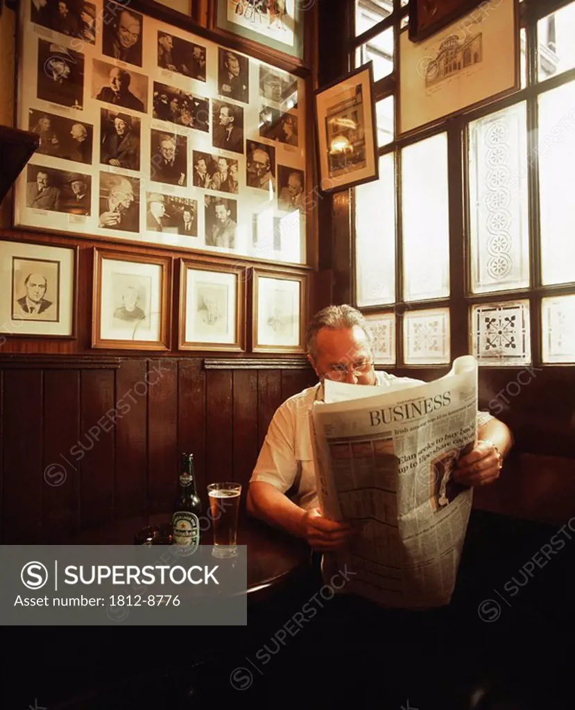 Dublin, Co Dublin, Ireland, Pub, Man reading a newspaper