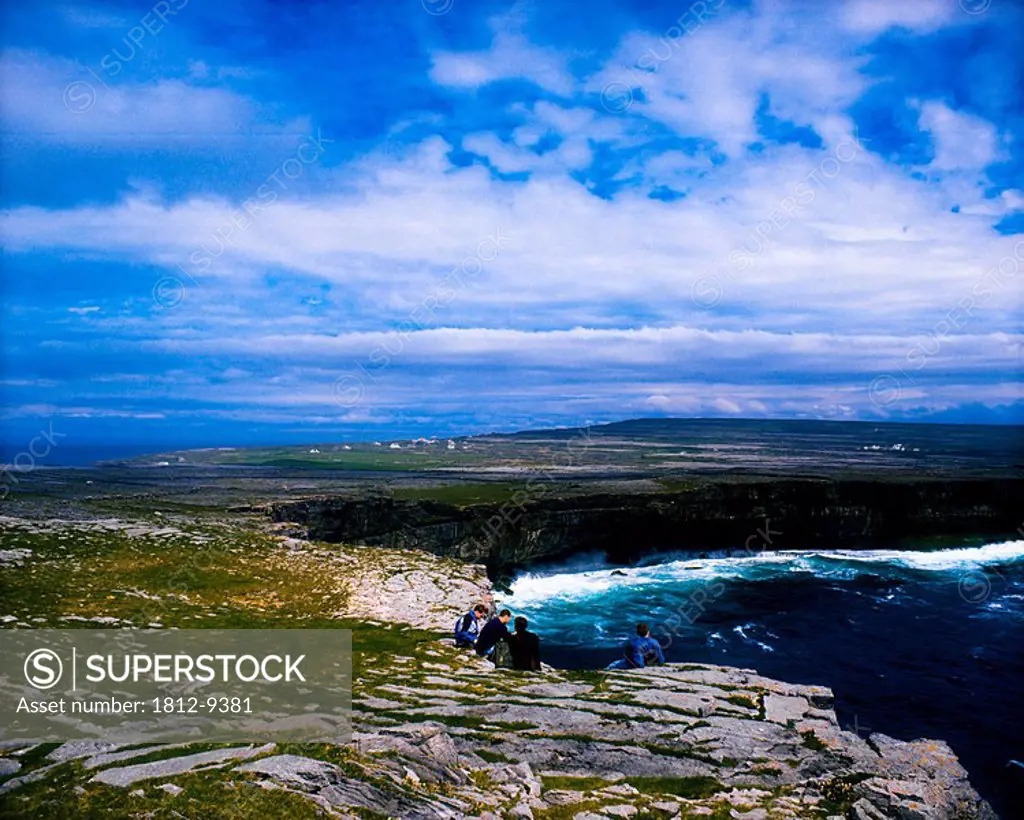 Dun Aengus, Aran islands, Ireland, People sitting on a cliff