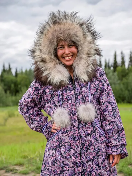 First Nations woman dressed in handmade traditional coat; Mayo, Yukon, Canada
