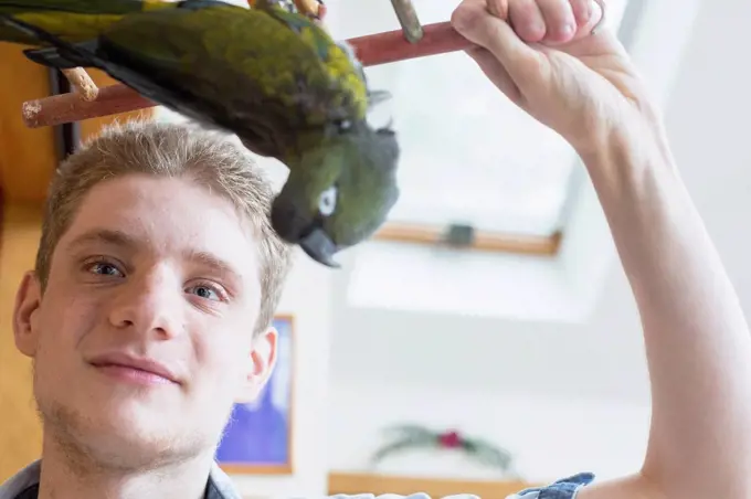 Boy with Anxiety Disorder playing with his pet bird