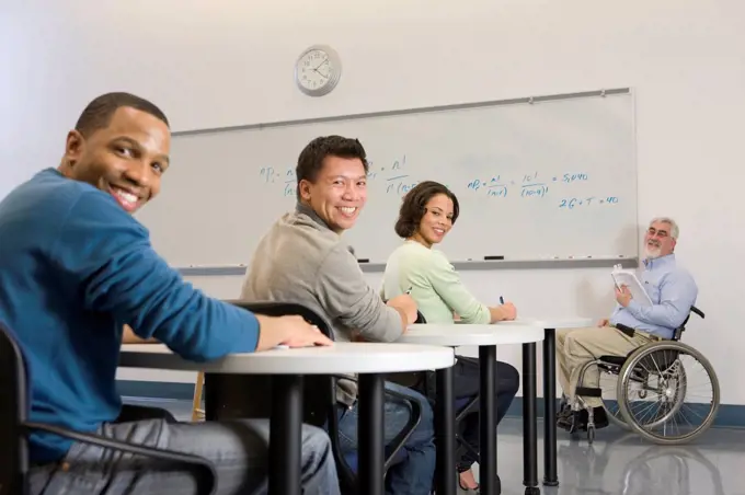 University professor with Muscular Dystrophy and students in a classroom