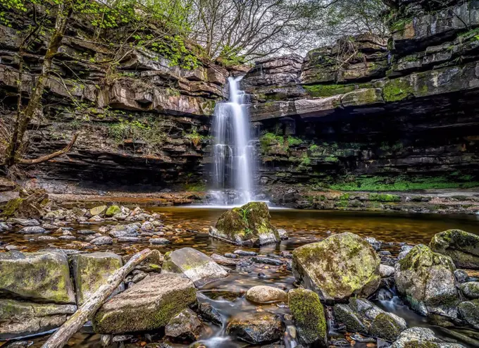 Summerhill Force is a picturesque waterfall in a wooded glade in Upper Teesdale. Heavily undercut, the recess behind the fall is known as 'Gibson's Ca...