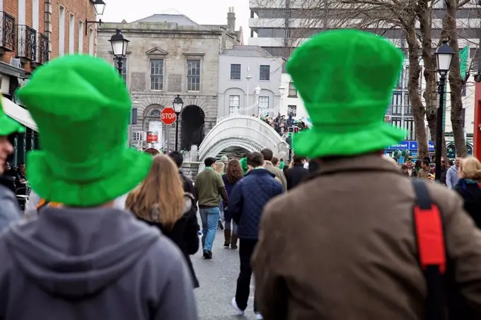 Dublin, Ireland, People Dressed Up In Green Hats Walking Down The Street