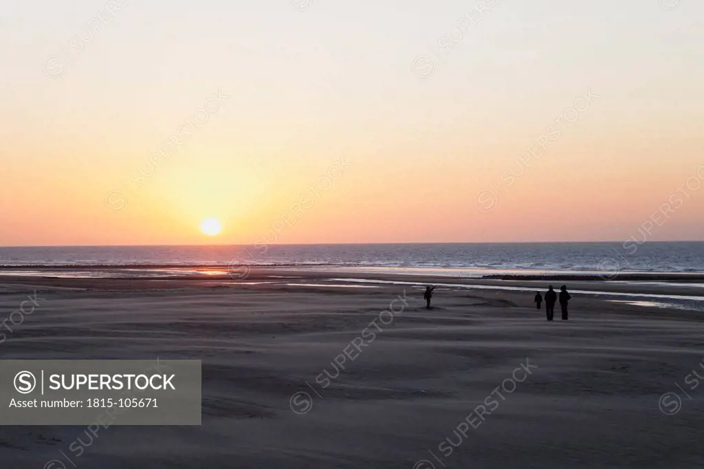 Belgium, Flanders, People on beach at sunset
