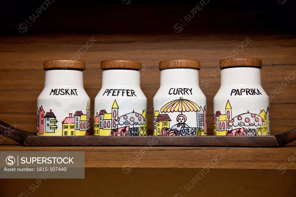 Variety of spice jars in rack, close up