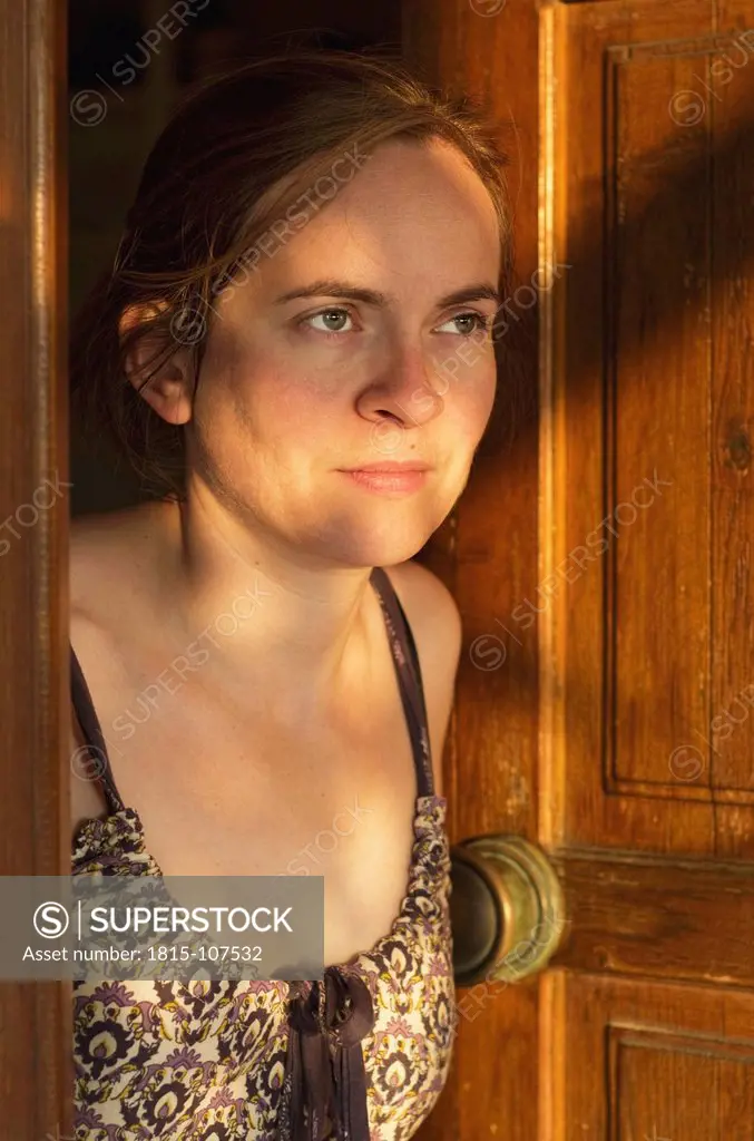 Greece, Ionian Islands, Ithaca, Mid adult woman at open door