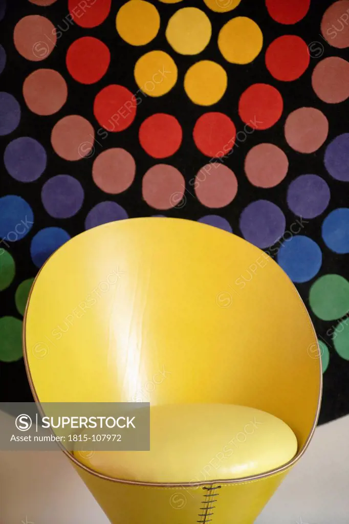 Germany, Upper Bavaria, Munich, Designed chair in new house with multicoloured background