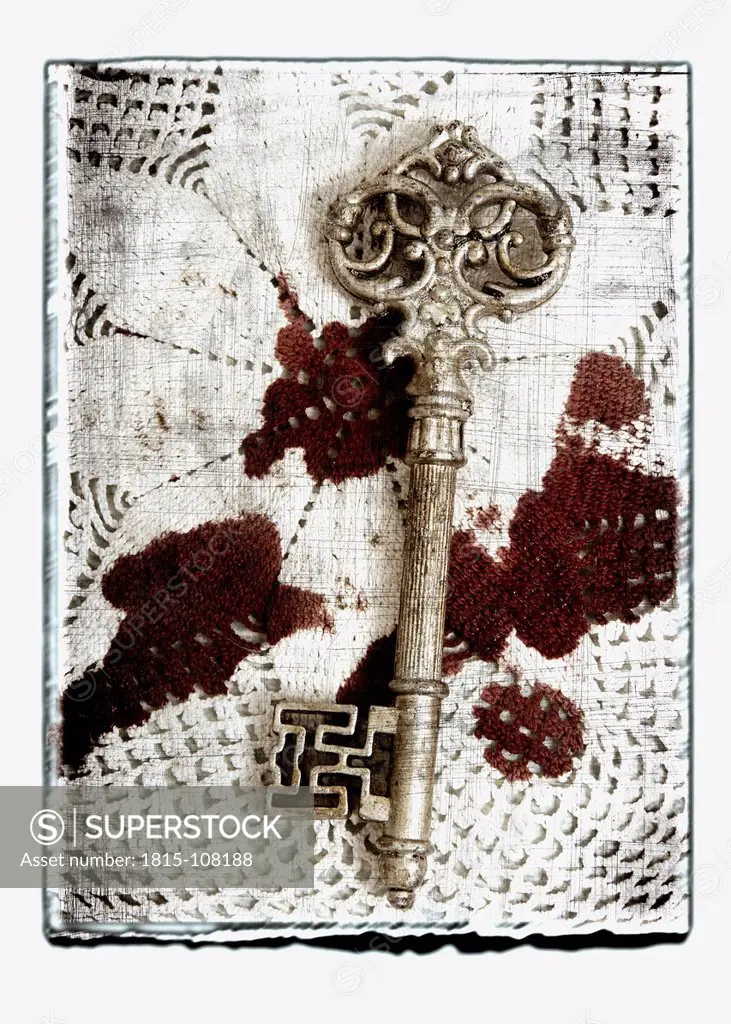Collage of old key on blood stained cloth